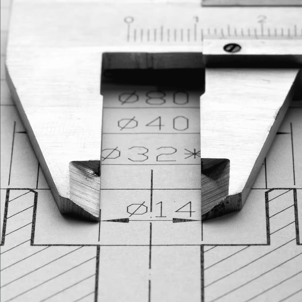 Vernier caliper measuring a part on a technical drawing