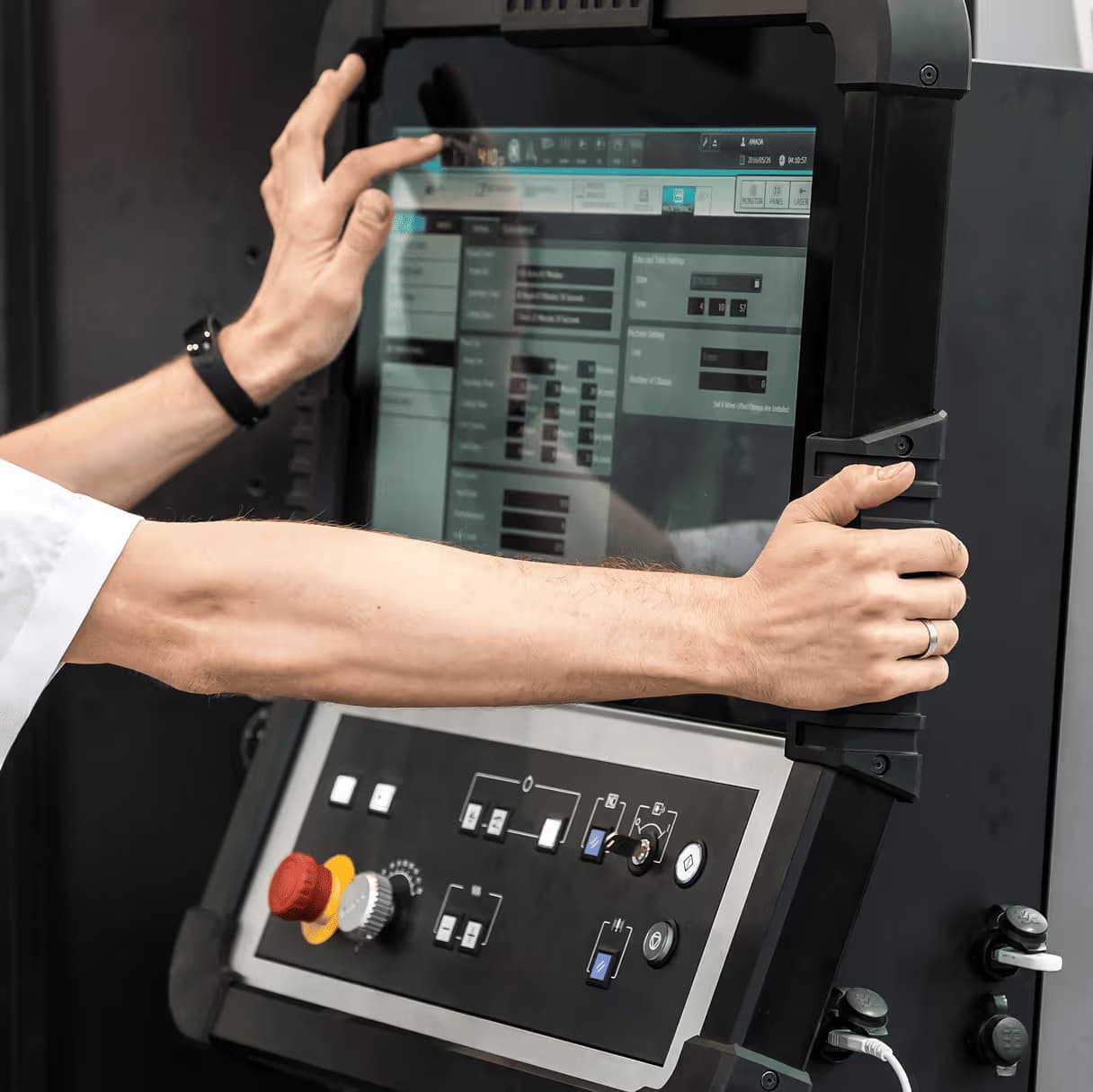 Person operating a CNC machine control panel